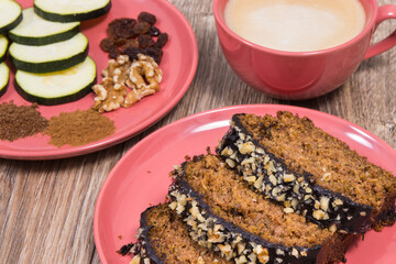 Fresh pastry made of zucchini and cup of white coffee. Delicious dessert. Wooden background