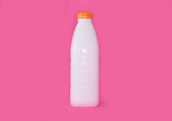 Bottle for milk on a bright pink background