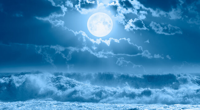 Night sky with moon in the clouds on the foreground stormy sea wave "Elements of this image furnished by NASA"
