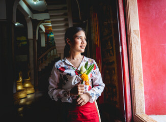 Beautiful Asian girl at big Buddhist temple dressed in traditional costume