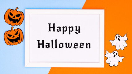 Creative Happy Halloween frame with horor pumpkins and ghosts on blue and orange background. Flat lay. Autumn holidays concept