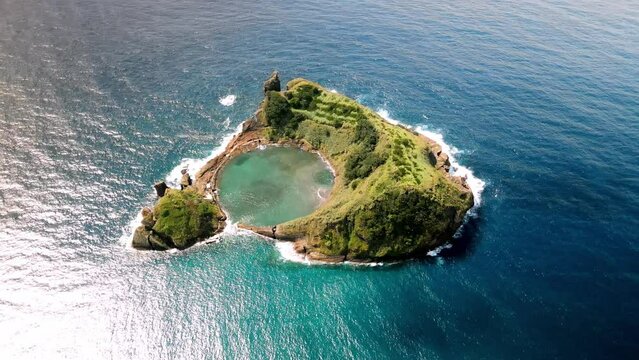 Aerial drone shot of small island of Vila Franca do Campo on Sao Miguel. Top rotating view of volcanic atoll in Azores. 