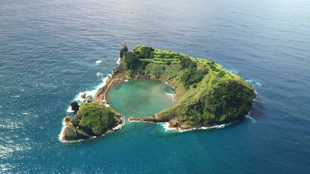 Aerial drone shot of small island of Vila Franca do Campo on Sao Miguel. Top rotating view of volcanic atoll in Azores. 