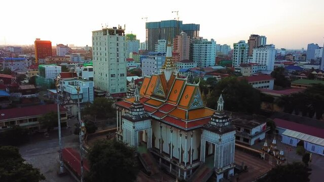 Aerial Panning Shot Of Wat Phnom Penh Temple In City Against Clear Sky