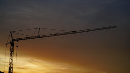 Tower crane silhouette on sunset background