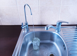 Sink in the kitchen with two taps - one for drinking filtered water, the second for washing dishes....