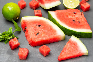 Watermelon slices, lime and basil sprig. Top view