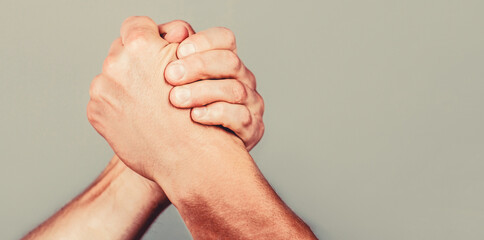 Arms wrestling. Closep up. Friendly handshake, friends greeting, teamwork, friendship. Handshake,...
