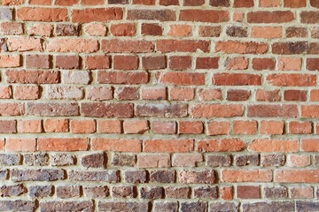 Brick wall background. Pattern brown color design decorative uneven cracked real stone wall surface with cement. Dry brick wall as seamless background