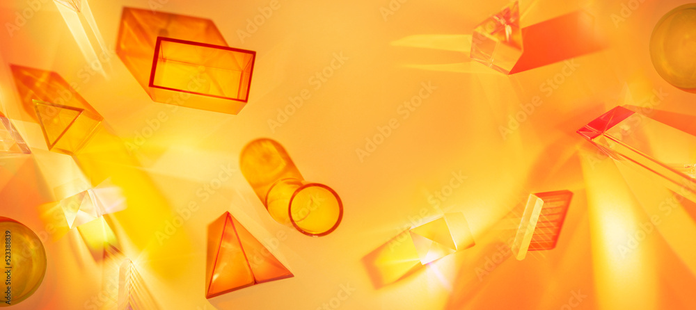 Wall mural abstract scene with geometric shapes and light rays on an orange-yellow background. set of colored t