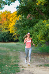 Young fitness woman running in summer nature
