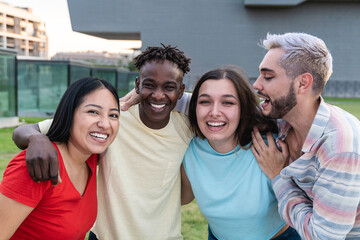 Young diverse group of friends having fun outside - Happy gen z people hugging outdoor - Focus on curvy girl face