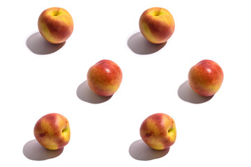 Pattern. Yellow-red nectarine with a black shadow. On a white background.