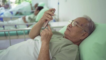 Portrait of happy old elderly Asian patient or pensioner people using a mobile smartphone device in nursing home in hospital. Senior lifestyle activity recreation. Retirement community. Health care - Powered by Adobe