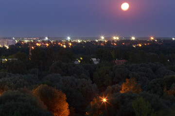 landscape of the night city with the moon
