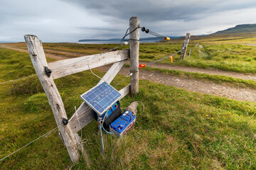 Obraz na płótnie Canvas Solar powered electric fence in Iceland fields