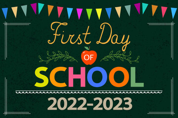 First Day of School greeting card. Text 2022-2023, red apple on school chalkboard with colorful garland. Back to school concept.	