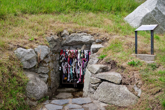 Ancient and Holy Well in the Dillon's Park in Dalkey, Ireland with colorful ribbons tied on the entrance gate.
