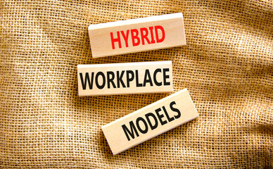 Hybrid workplace models symbol. Concept words Hybrid workplace models on wooden blocks on canvas. Beautiful canvas background. Business hybrid workplace models concept. Copy space