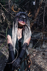 Naklejka premium Forest witch in a pine forest