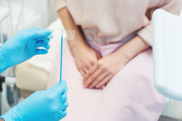 Close-up of woman having test for sexually transmitted disease with doctor - 523398425