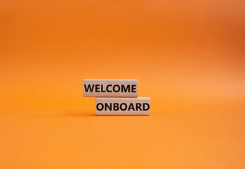 Welcome onboard symbol. Concept words Welcome onboard on wooden blocks. Beautiful orange...