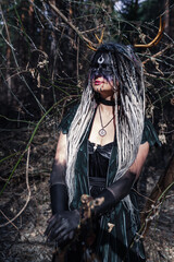 Naklejka premium Forest witch in a pine forest