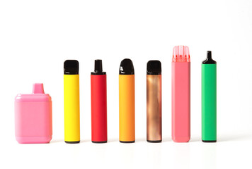 A set of colorful disposable electronic cigarettes of different shapes on a white background....