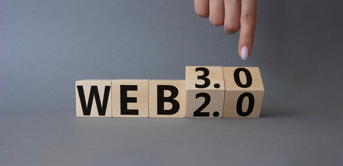Web 3.0 vs Web 2.0 symbol. Finger points at cubes with the words web 3.0 and web 2.0. Beautiful orange background. Businessman hand. Business concept. Copy space