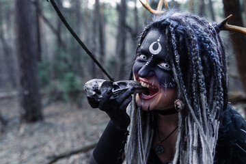 Naklejka premium Forest witch in a pine forest