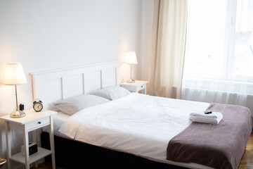Fototapeta na wymiar big bed in cozy white bedroom