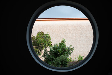 round window tree and house