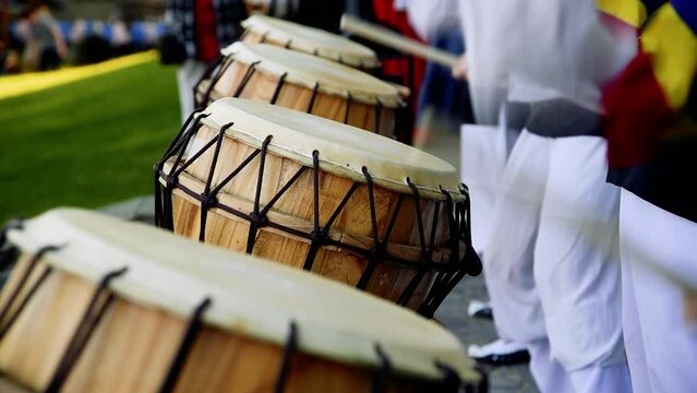 Group of musicians play drums outdoors