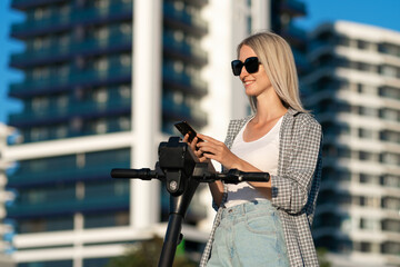 Portrait of a young, smiling, slender blonde in denim shorts, white T-shirt, shirt activating an...