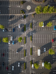 Aerial view of a supermarket carpark with parked cars and empty spaces