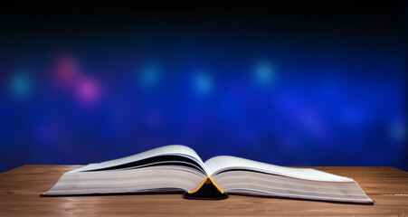 Open Holy Bible on the wooden table