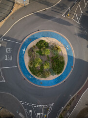Aerial view of a UK roundabout with trees and keep clear text