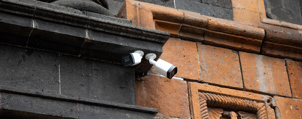 Controlled security cameras on the wall