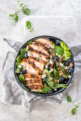 Grilled chicken breast, fillet and fresh vegetable salad of lettuce, arugula, spinach, avocado,...