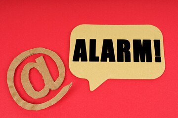On a red surface, a symbol and a sign with the inscription - ALARM