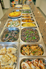 Varied types of food in self service restaurant platters