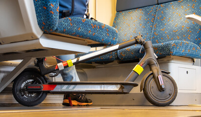 A passenger on the train is traveling with an electric scooter