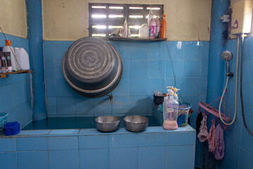 A bathroom with a large water tank in a Thai house