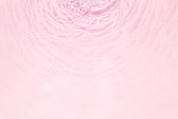 Closeup of pink water surface texture with splashes and bubbles