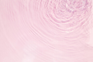 Closeup of pink water surface texture with splashes and bubbles