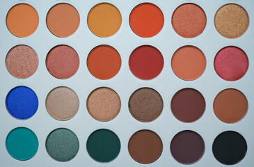 Selective focus of eyeshadow palette with various colors in pearly and matte closeup
