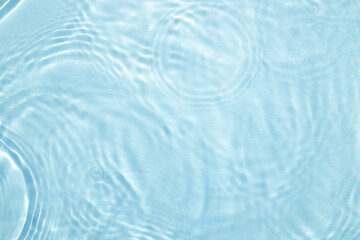 Fototapeta na wymiar Closeup of blue water surface texture with splashes and bubbles
