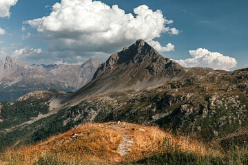Fototapeta na wymiar The path in mountain hills in Swiss Alps. Scenic landscape