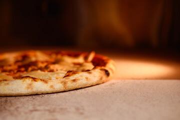 Close up view of baked pizza on stone in oven 