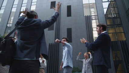 Happy team appreciate employee outside office building. Best worker recognition.